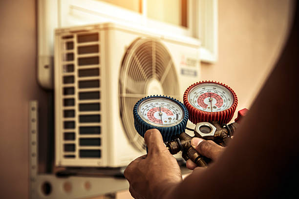 Professional Air Conditioning Service technician working in Atalissa, IA